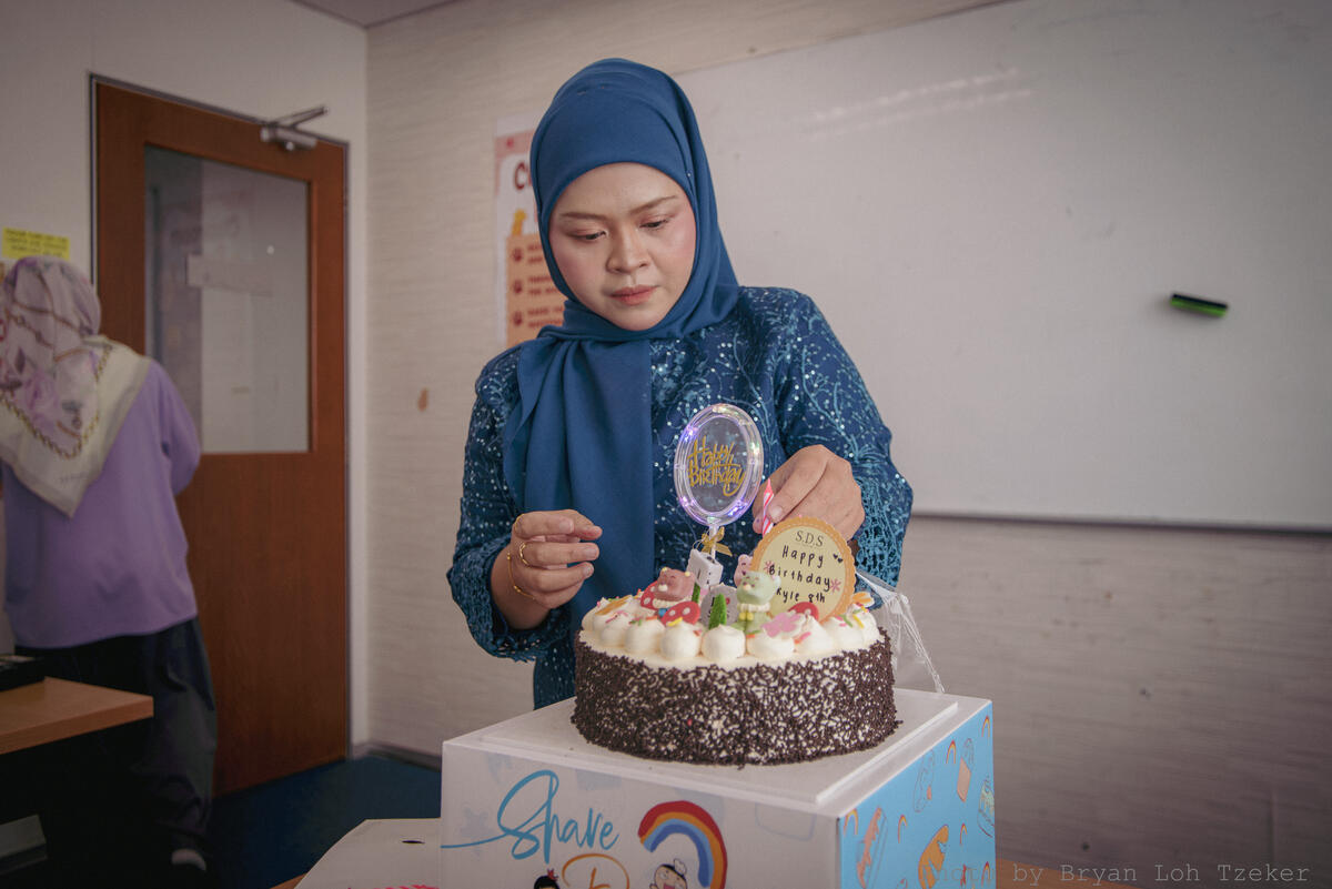 Pupils singing as their classmate blows out the birthday candles