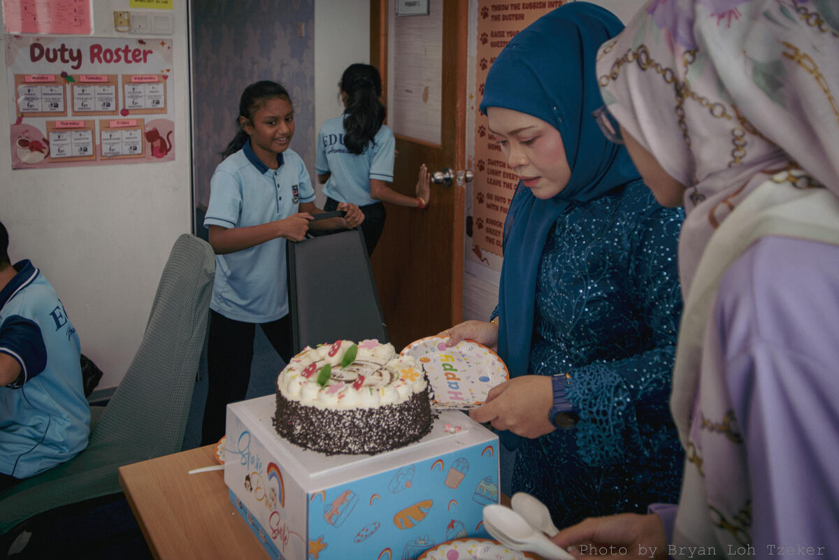 Pupils singing as their classmate blows out the birthday candles