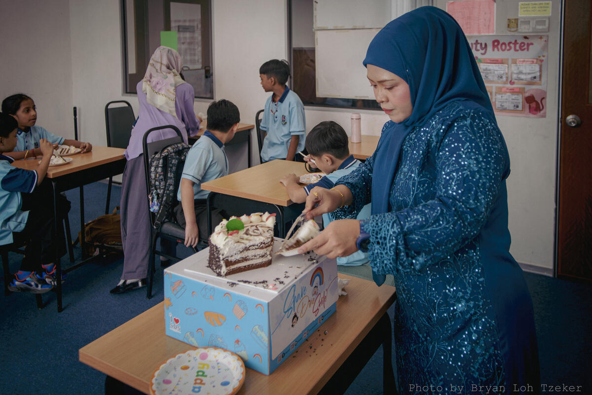 Pupils singing as their classmate blows out the birthday candles
