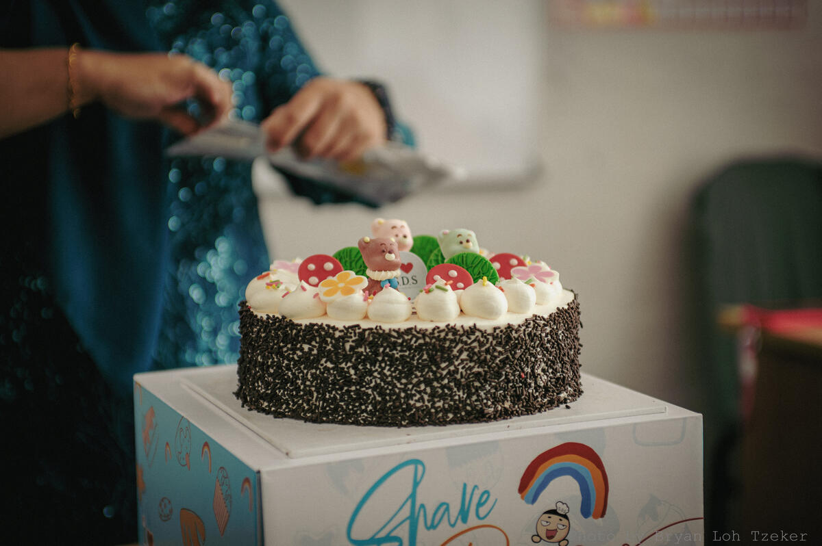 Pupils singing as their classmate blows out the birthday candles