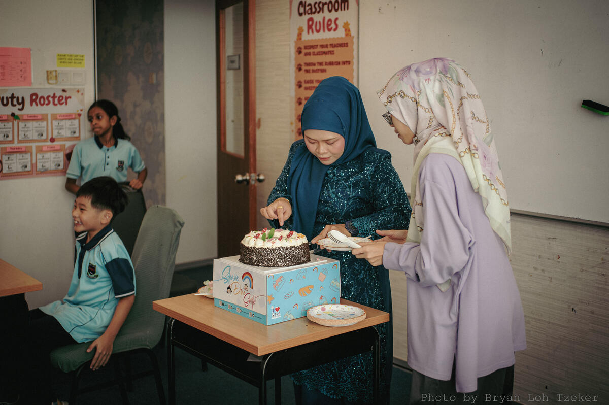 Pupils singing as their classmate blows out the birthday candles