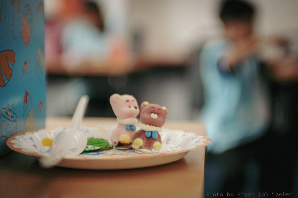Pupils singing as their classmate blows out the birthday candles