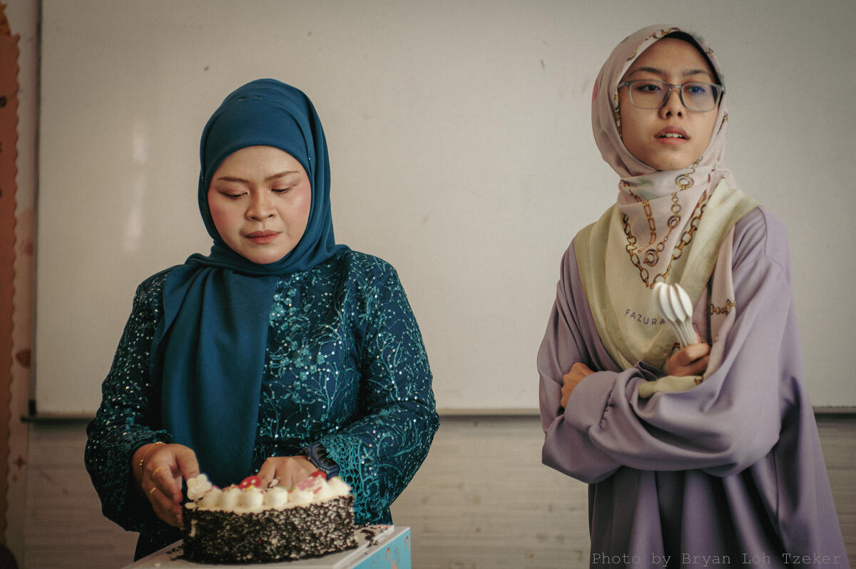 Pupils singing as their classmate blows out the birthday candles