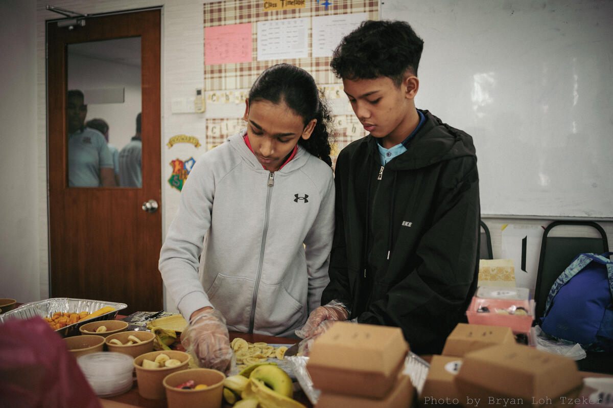 Year 6 pupils packing labelled food boxes