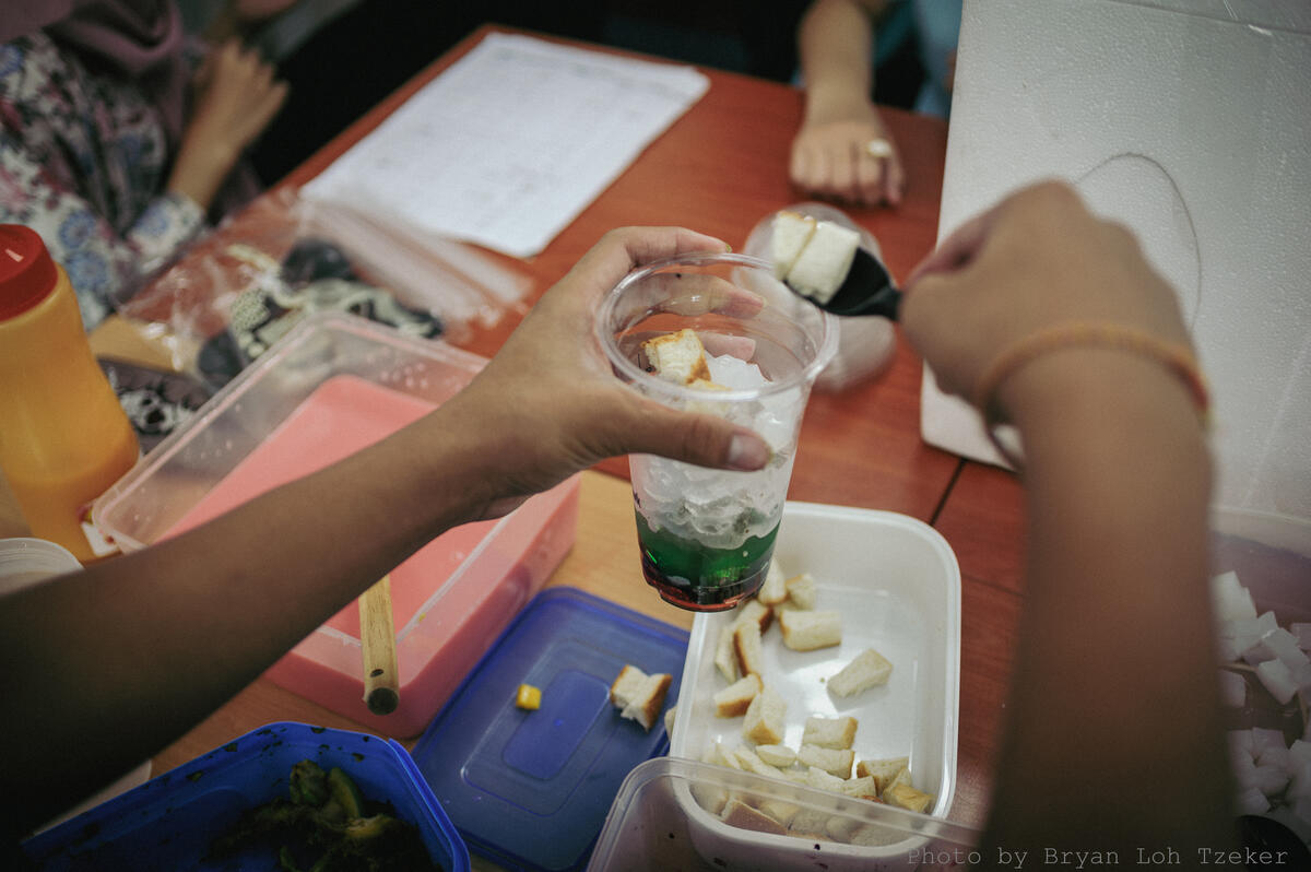 Year 6 pupils packaging food with gloves on