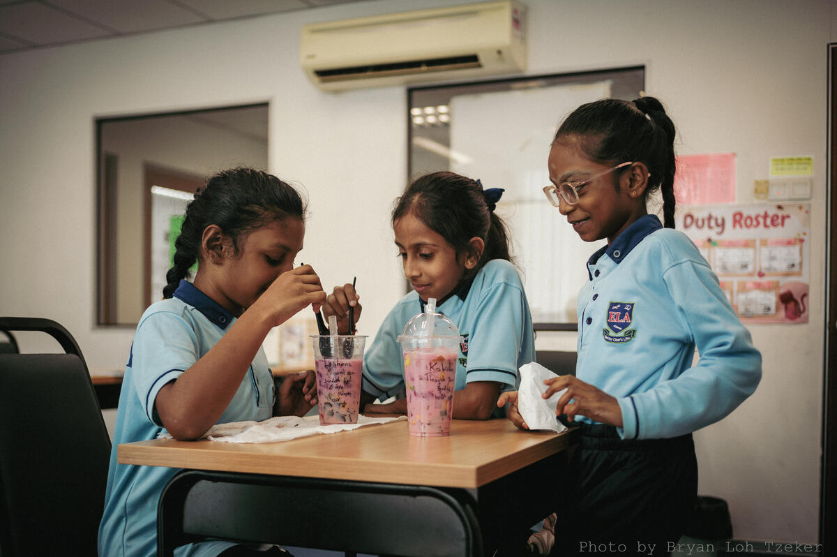 Pupils arranging cups of fruit for display