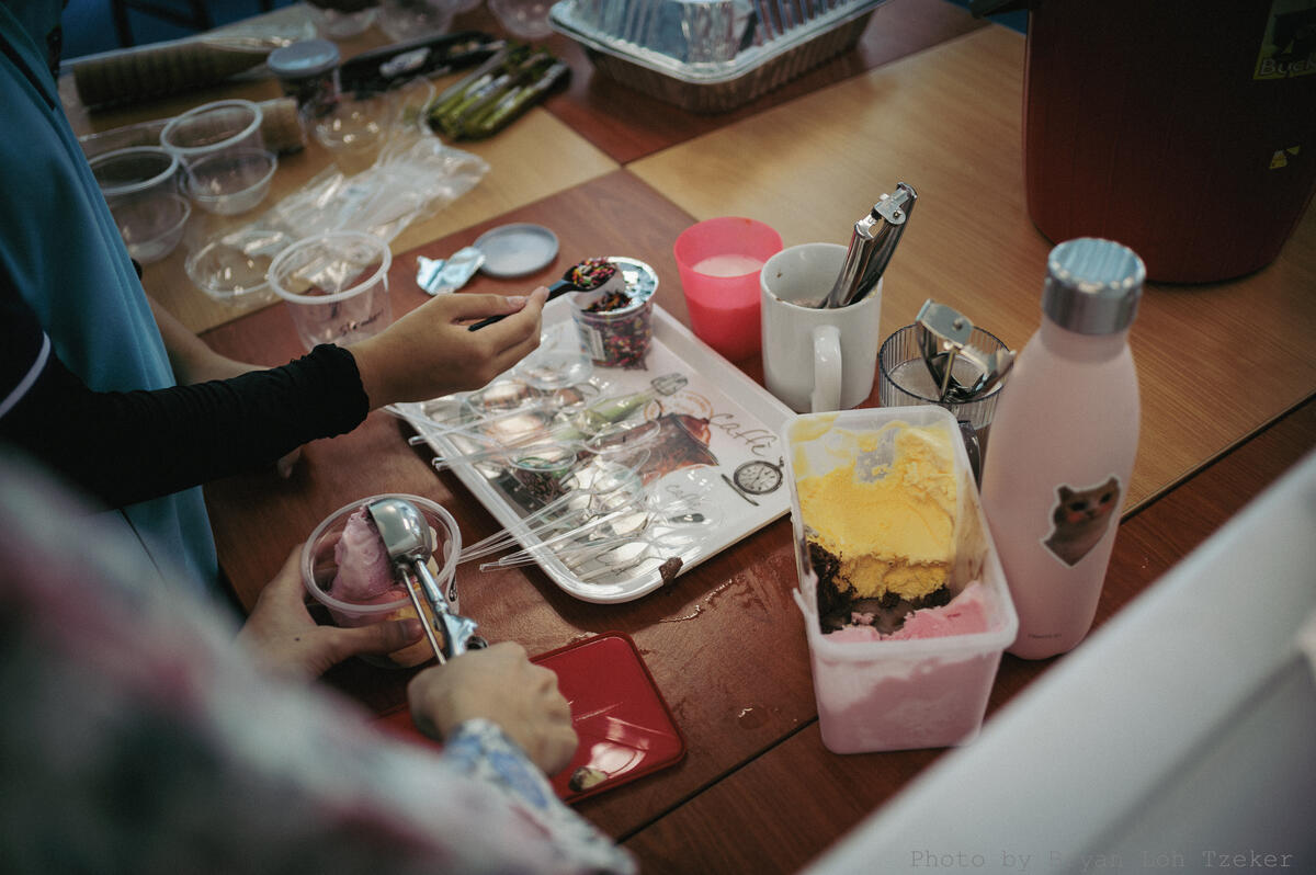 Pupils decorating their food stall sign