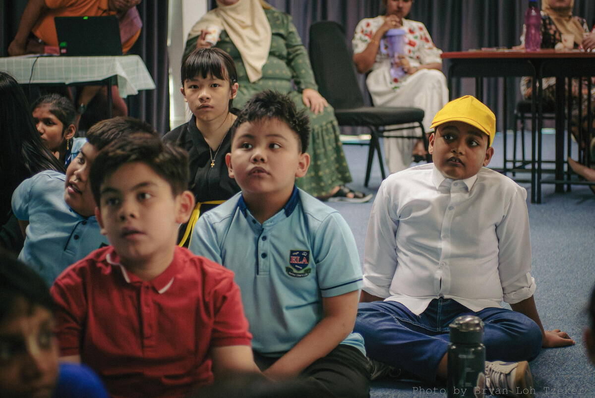 A pupil singing on stage during the Merdeka celebration