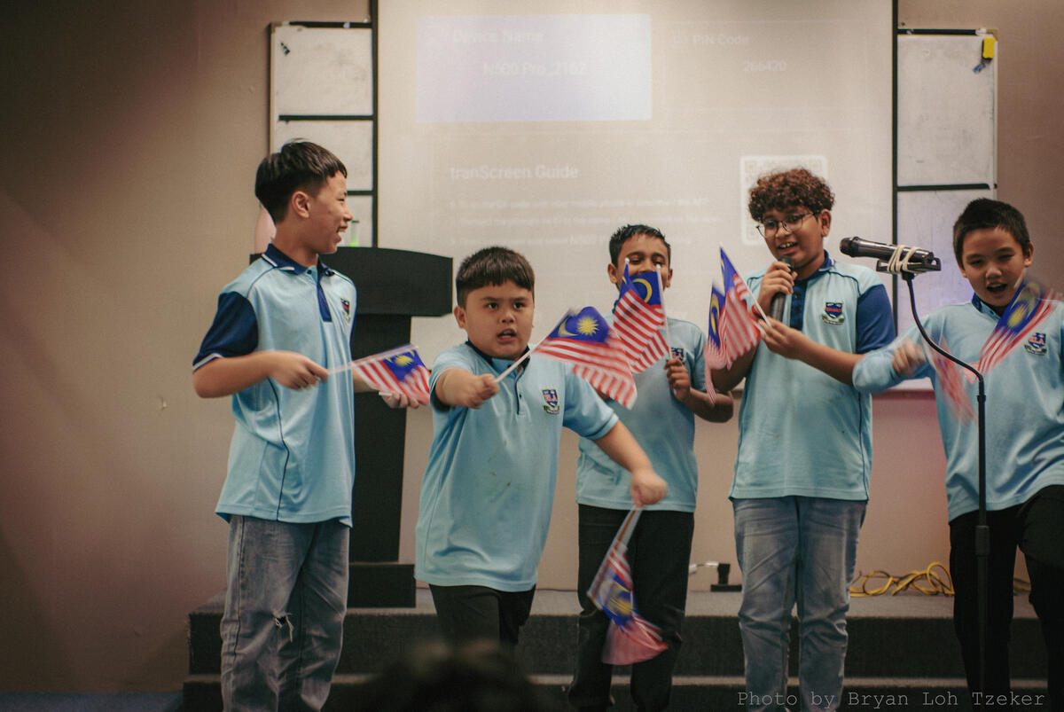 Pupils in songkok performing at the Merdeka concert