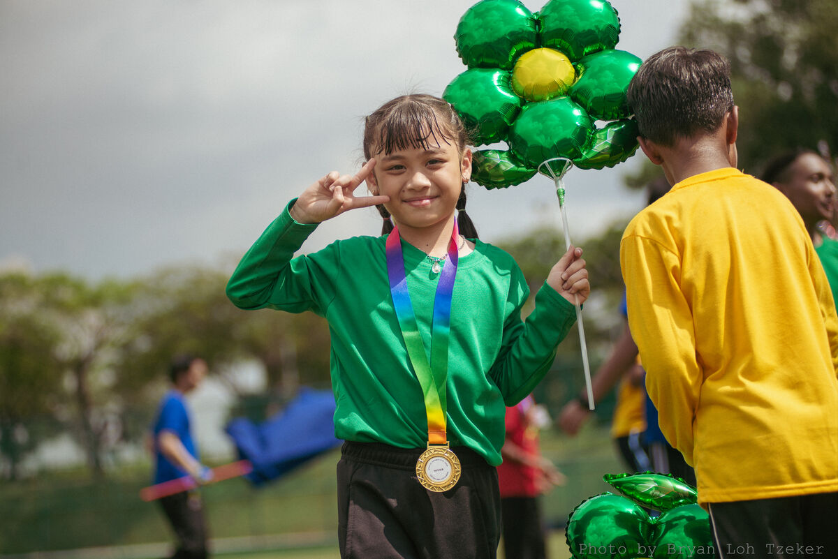 Studentposingwithmedalandballoonhero-26