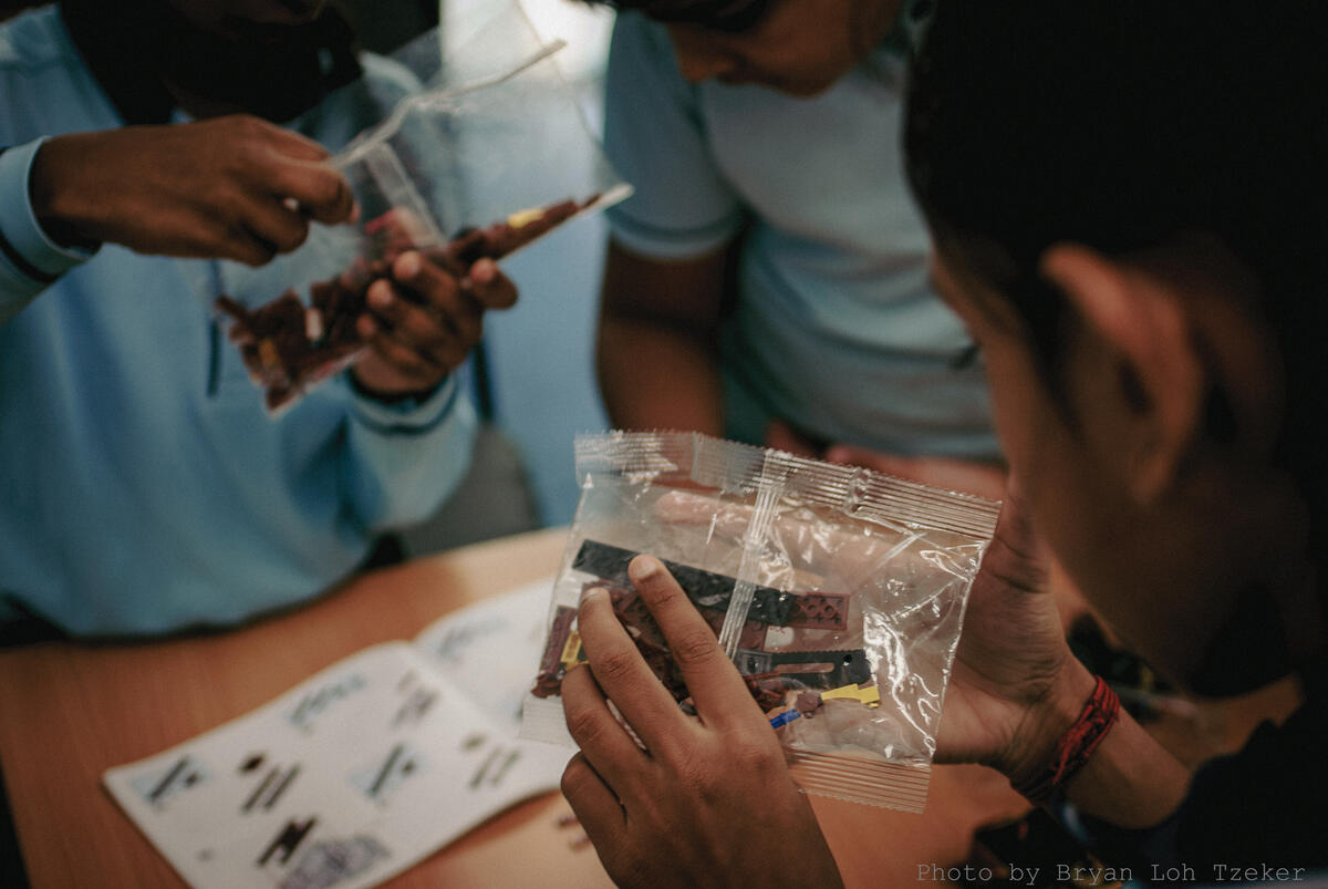 Pupils reading the Lego instruction booklet together