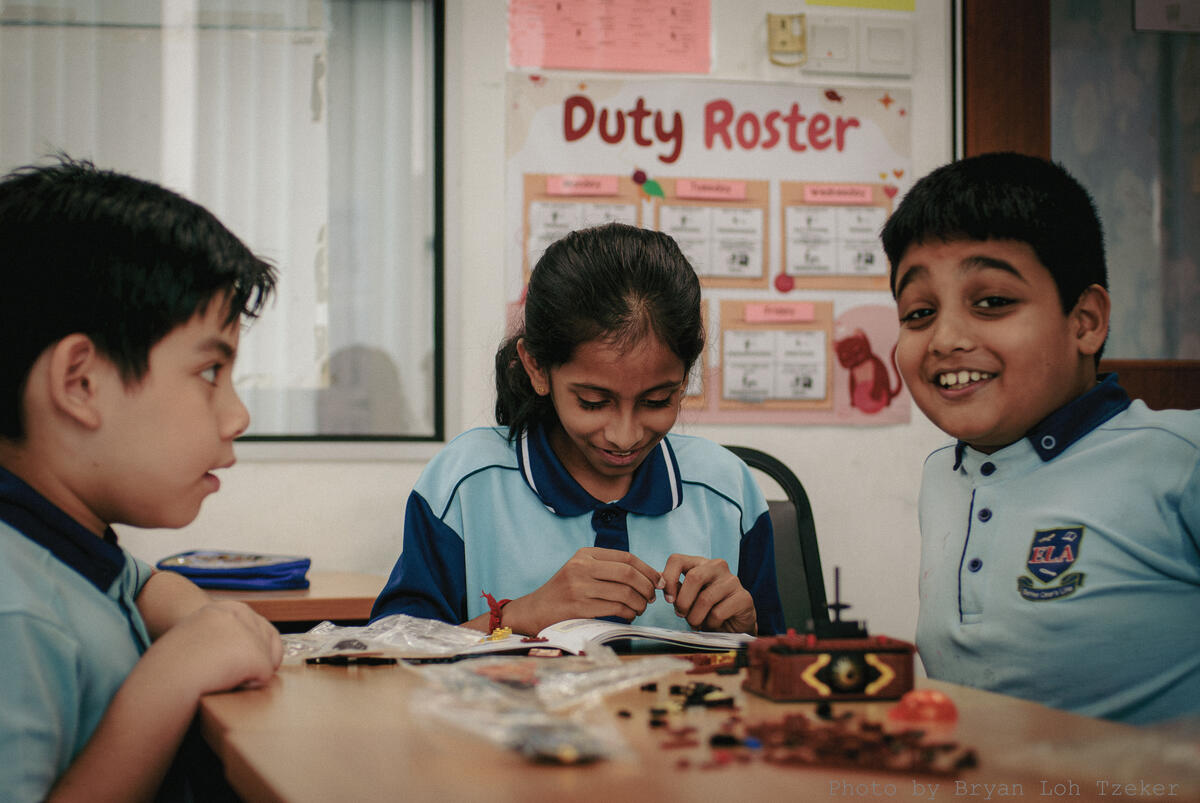 Pupils assembling Lego pieces in a small group