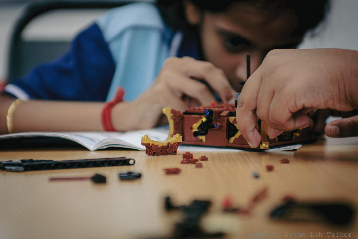 Pupils attaching pieces to their Lego construction